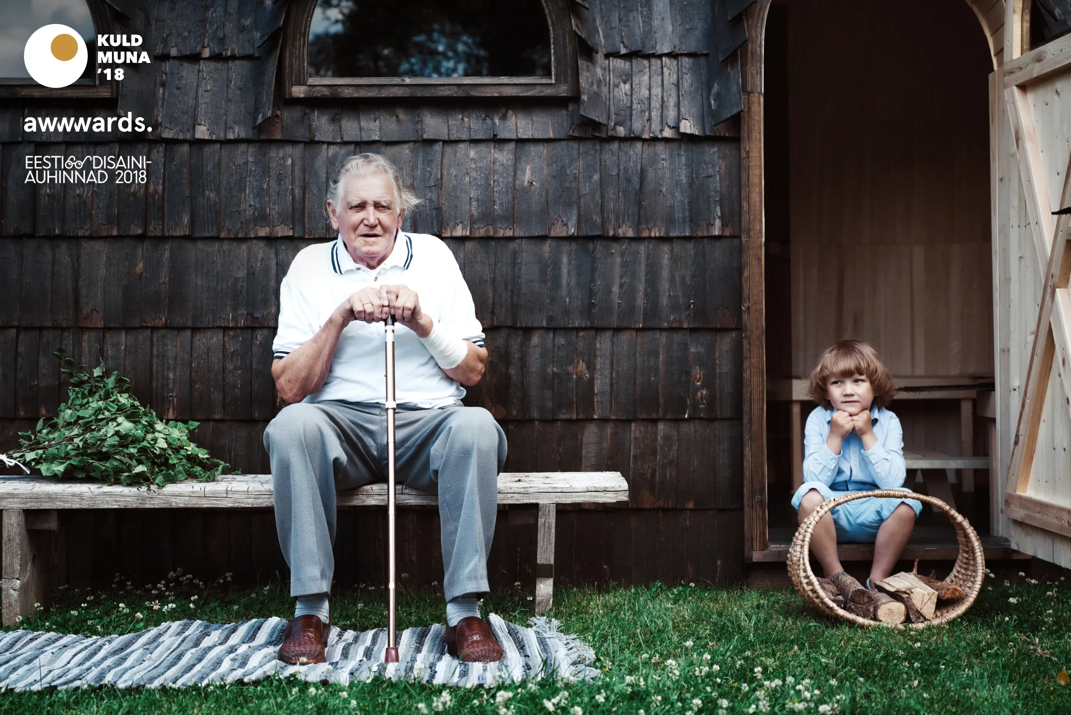 Iglucraft — grandfather and child outside a shingled sauna
